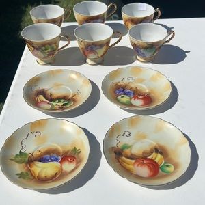 Fruit pattern trimmed gold tea cup and saucer